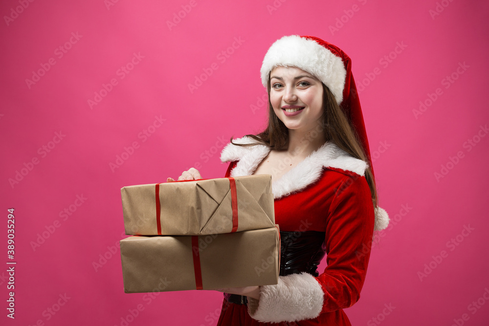 Beautiful young woman in Santa Claus costume against the red background. Beautiful young woman in Santa Claus costume against the red background.