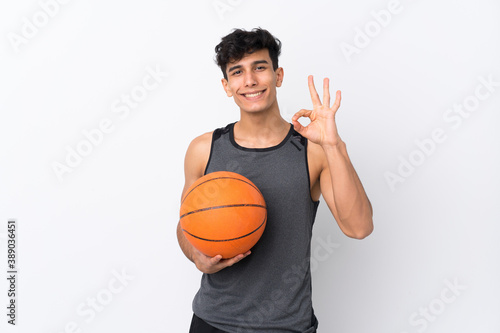 Basketball player man over isolated white background showing ok sign with fingers