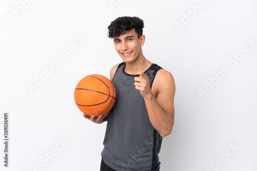 Basketball player man over isolated white background points finger at you with a confident expression © luismolinero
