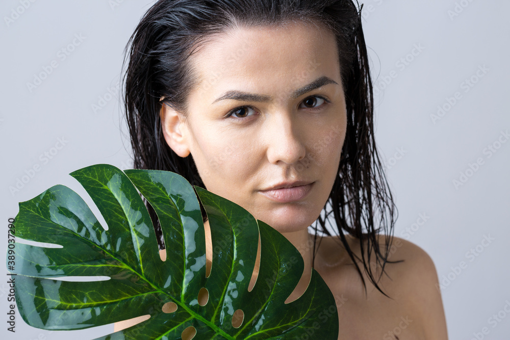 Beauty Woman with natural green palm leaf portrait. Fashion, beauty, make-up, cosmetics. Beauty Woman with natural green palm leaf portrait. Fashion, beauty, make-up, cosmetics.