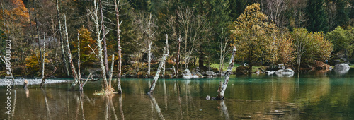 panorama view of small lake with reflections and multicolor woods, in autumn season lake in Val di Mello, Val Masino , Italy - lombardy.