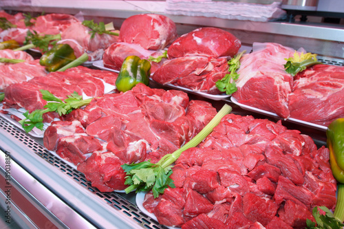 Fresh and raw meat department. Grocery shop shelves with products inside a grocery store market in Rome in Italy.