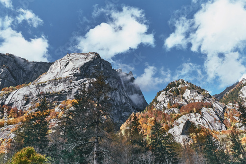 panorama view of mountain and multicolor woods, in autumn season in Val di Mello, Val Masino , Italy - lombardy.