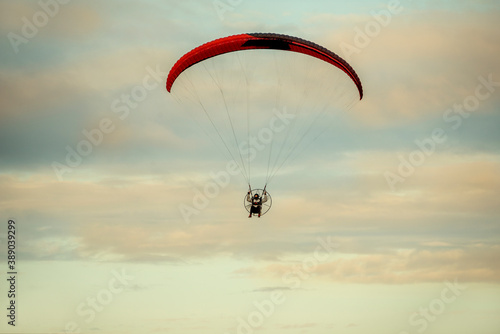 Paragliding flight in the overcast sky