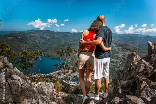 Young couple enjoying a view of Perucac lake and river dam from a magnificent viewpoint in Tara mountain photo