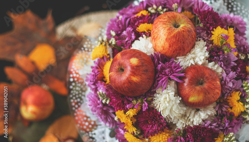 Autumn bouquet of flowers and apples. Autumn bright background with apples, chrysontema, dry leaves. September October November. Seasonal autumn background with yellow and orange colors.