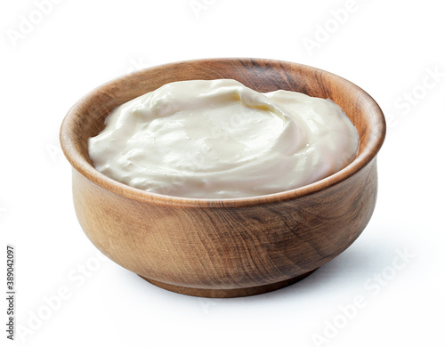 cream sour in traditional russian wooden bowl  isolated white background