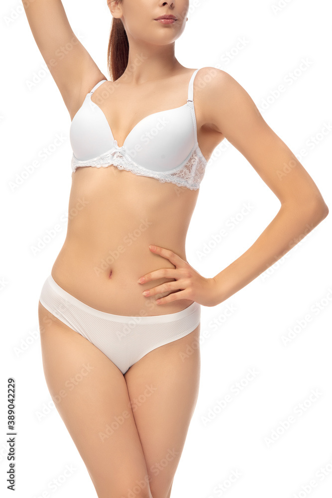 Beautiful female belly isolated on white background. Beauty, cosmetics, spa, depilation, treatment and fitness concept. Fit and sportive, sensual body with well-kept skin in underwear. Beautiful female belly isolated on white background. Beauty, cosmetics, spa, depilation, treatment and fitness concept. Fit and sportive, sensual body with well-kept skin in underwear.