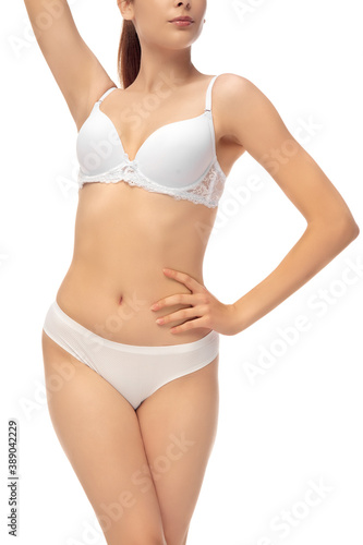 Beautiful female belly isolated on white background. Beauty, cosmetics, spa, depilation, treatment and fitness concept. Fit and sportive, sensual body with well-kept skin in underwear. © master1305