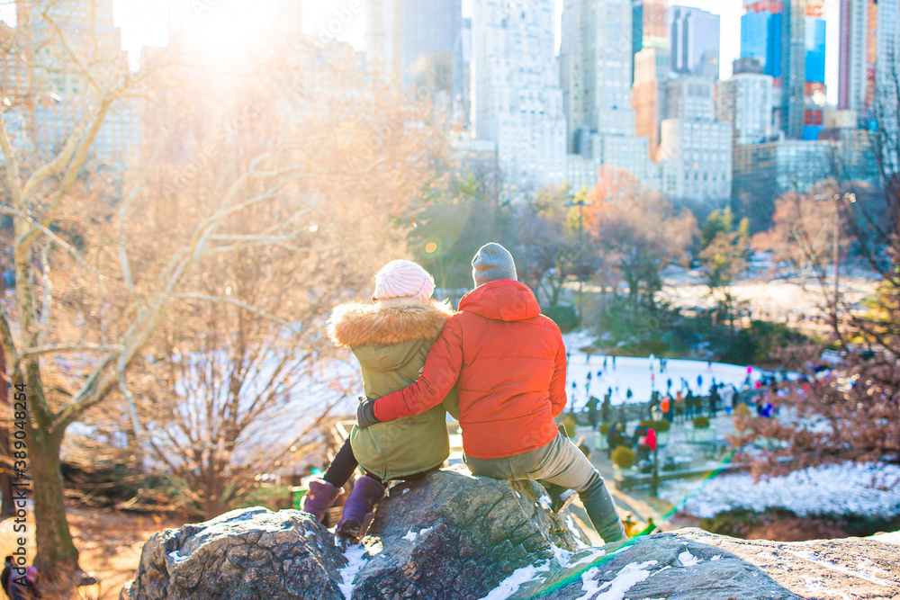 Happy couple enjoy the view of famous ice-rink in Central Park in New York City Happy couple enjoy the view of famous ice-rink in Central Park in New York City