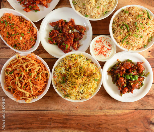 Assorted indian foods Dragon chicken,chicken biryani,chicken fried rice,veg noodles and garlic chicken on wooden background. Dishes and appetizers of indian cuisine