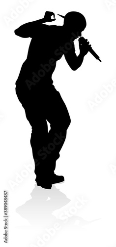 A singer pop, country music, rock star or hiphop rapper artist vocalist singing in silhouette