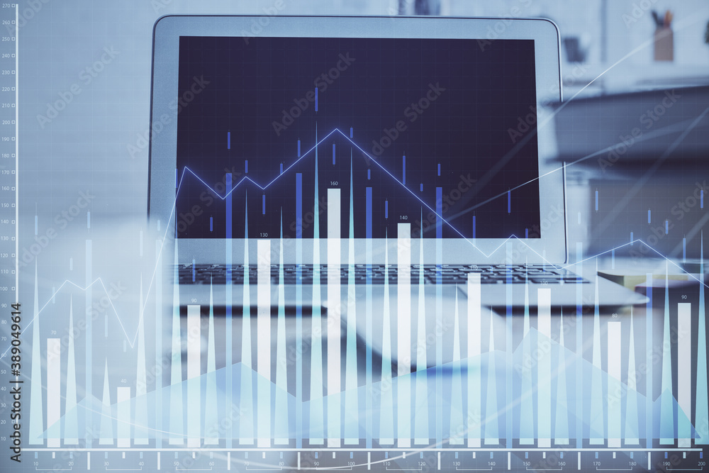 Stock market chart hologram drawn on personal computer background. Multi exposure. Concept of investment. Stock market chart hologram drawn on personal computer background. Multi exposure. Concept of investment.