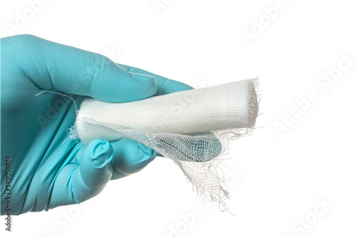 Konstfotografi A hand in a medical glove holds a bandage on a white background.