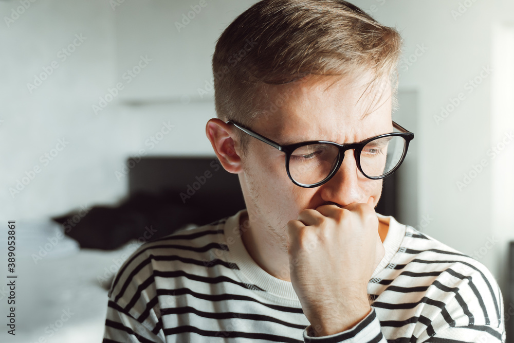 Young businessman feeling sore and tired. Frustrated millennial covering his face with hands . Upset Worker in eyeglasses overworking exhausted. trouble sleepy, suffering from conjunctivitis eyestrain Young businessman feeling sore and tired. Frustrated millennial covering his face with hands . Upset Worker in eyeglasses overworking exhausted. trouble sleepy, suffering from conjunctivitis eyestrain