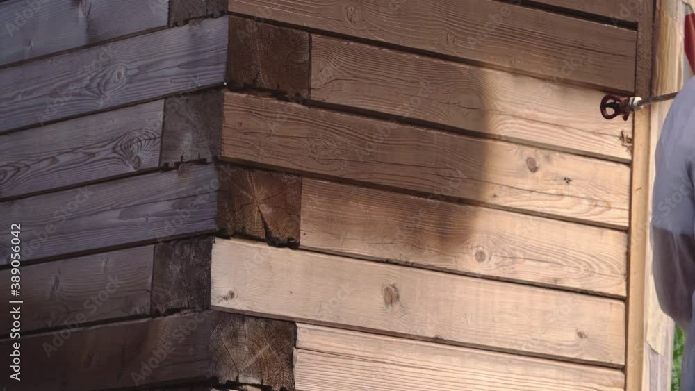 painting a house made of wood with brown paint painting a house made of wood with brown paint