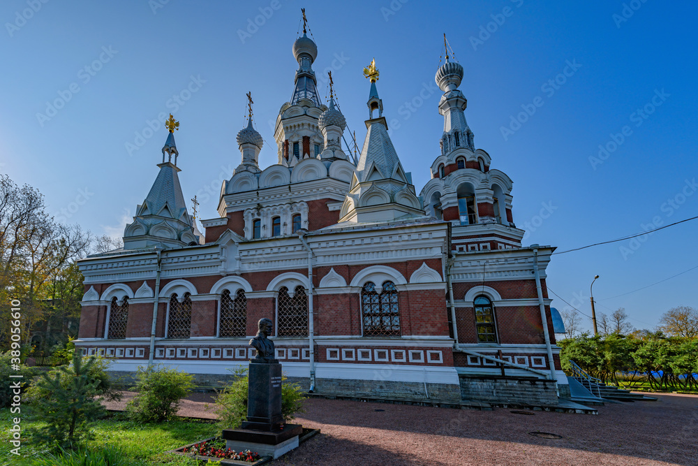 The Cathedral Orthodox church of St. Nicholas the Wonderworker and sculptural bust of the Russian Emperor Nicholas II in front at sunny autumn morning in Pavlovsk, near St.Petersburg, Russia