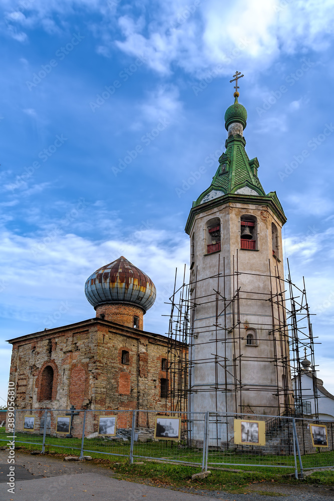 The monastery cathedral church (X-XIth centuries) of St. Nicholas the Wonderworker and bell tower in the scaffolding  under reconstruction in a StaroLadozhsky Nikolsky male monastery. Russia