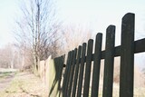 Detailed side view of old wooden fence during sunny spring day in countryside.