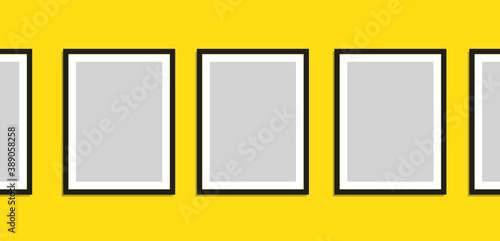 A Series of Blank Picture Frames on a Bright Yellow Wall