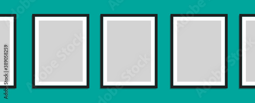 A Series of Blank Picture Frames on a Bright Aqua Colored Wall