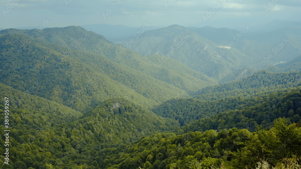 View of the green mountains. Clouds over the hills. View of the green mountains. Clouds over the hills.
