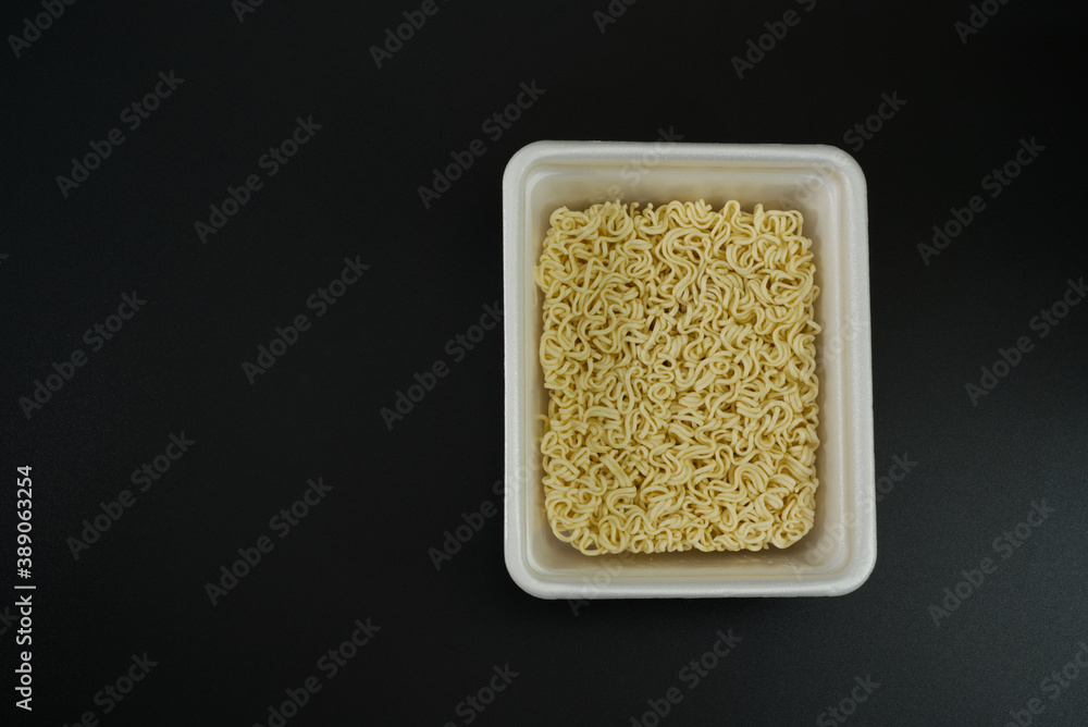 Dry instant noodles in rectangle plastic plate, top view Dry instant noodles in rectangle plastic plate, top view
