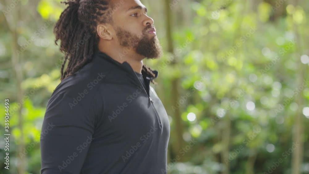 Camera tilts up on a handsome black athlete skipping with a jump rope, in slow motion Camera tilts up on a handsome black athlete skipping with a jump rope, in slow motion
