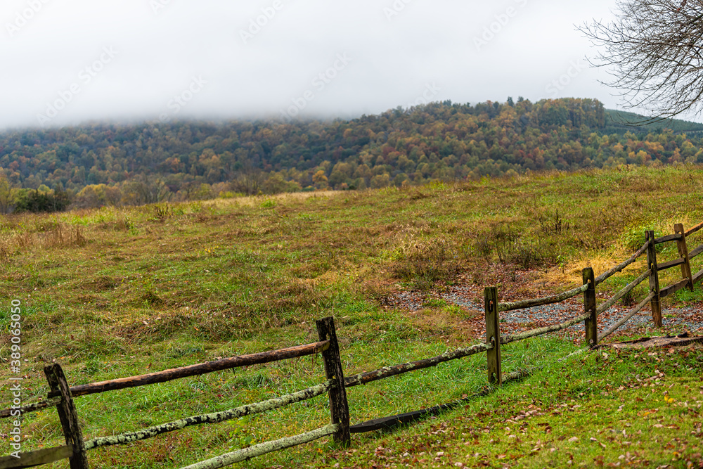 Ash Lawn-Highland area with farm rural countryside old fence in Albemarle County, Virginia during autumn fall season with cloudy day and hill