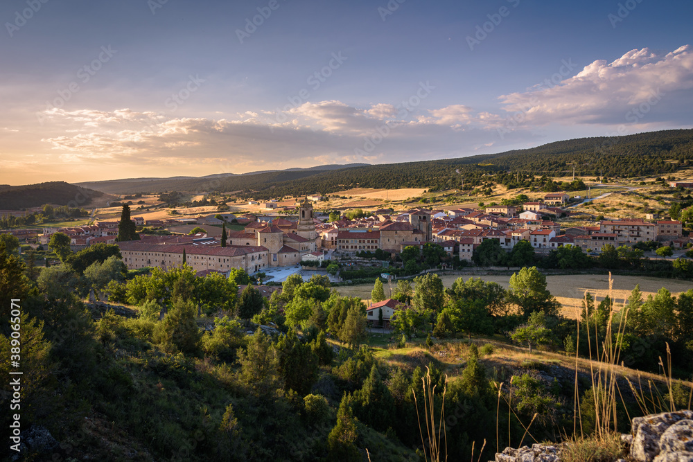 City landscape of Santo Domingo de Silos from a rock on the top of the hill and the Monastery of Silos in the city center at sunset, Burgos, Spain