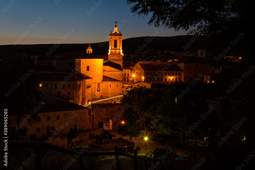 City landscape of Santo Domingo de Silos with the famous Monastery of Silos illuminated at sunset, Burgos, Spain
