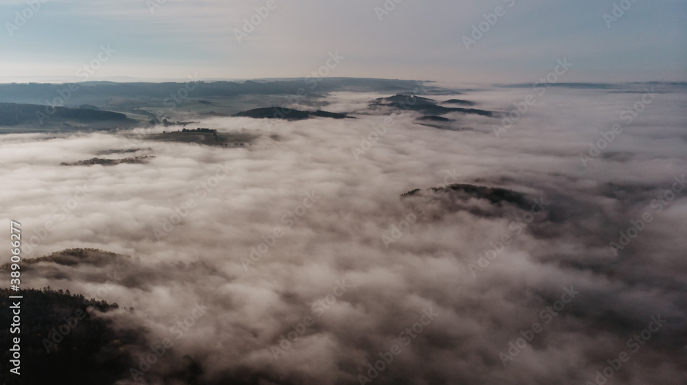Aerial view of morning foggy landscape. Fall autumn peaceful scenery. Misty calm atmosphere. Drone photo of Czech mountains. Trees in fog. Fairy tale land.Meditation dreamy concept.