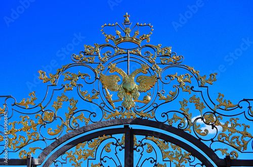 Golden two-headed eagle and crown on the gates of the Great Catherine Palace. Russia Pushkino 08/17/2020