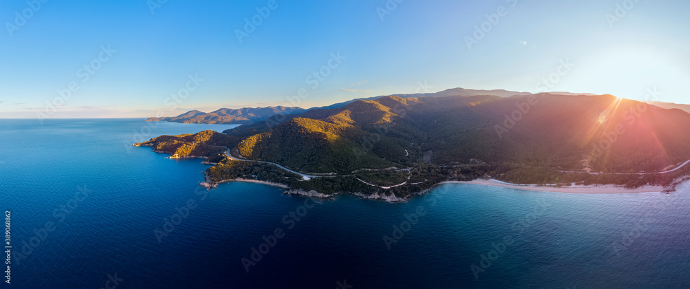 Drone panorama of sunset in Halkidiki with blue sea and mountains