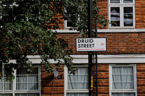 A traditional London location sign named Druid street is seen in front of an apartment building in Southwark borough, London, United Kingdom.