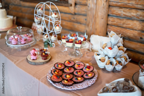 Mini cakes  biscuits and sweets displayed on table  closeup shallow depth of field photo