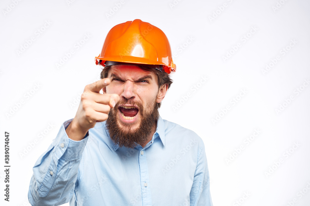 Man in an orange helmet shirt Engineering work construction cropped view Man in an orange helmet shirt Engineering work construction cropped view