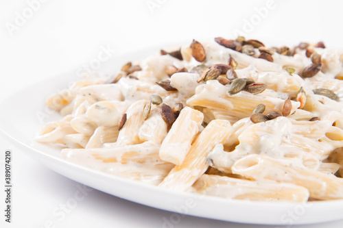 Pasta with blue cheese and cream sauce, sprinkled with roasted pumpkin seeds
