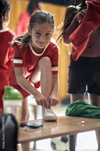 A little girl posing for a photo while preparing for a training. Children team sport