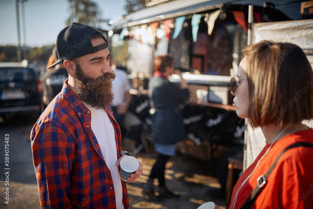 hipster having a conversation with a cool female, wearing sunglasses hipster having a conversation with a cool female, wearing sunglasses
