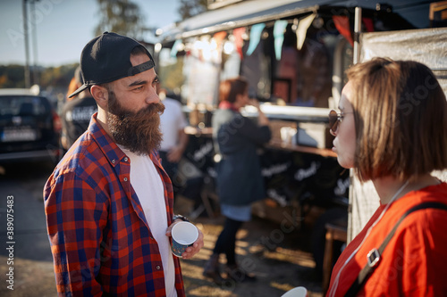 hipster having a conversation with a cool female, wearing sunglasses © luckybusiness