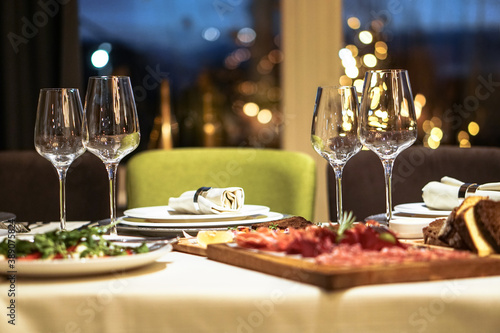 Nicely served New Year s table in the restaurant. Christmas night in a cafe or at home. Stock photo for design