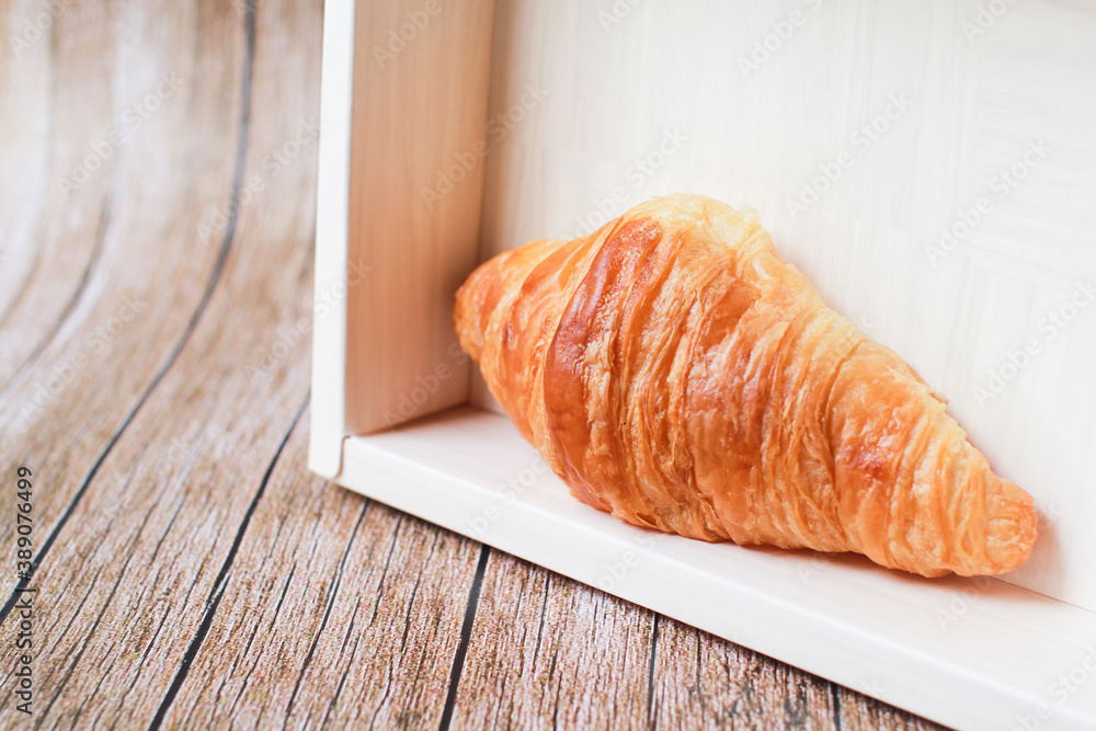 Fresh croissants on a wooden table and on the bamboo basket. Fresh croissants on a wooden table and on the bamboo basket.