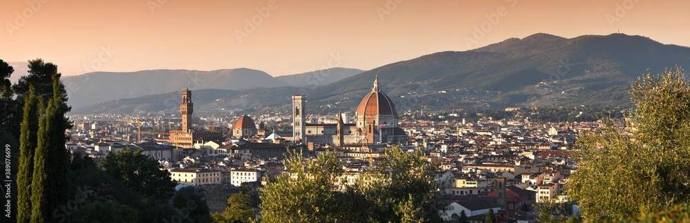 Panoramic view of the skyline of the city of Florence at sunset from the hills near Piazzale Michelangelo. Giotto's bell tower and the beautiful Cathedral of Santa Maria del Fiore. Italy.