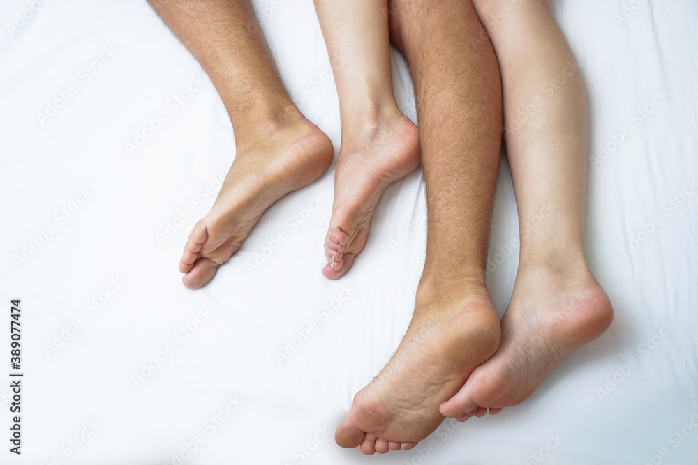 Love between a man and a woman with naked bodies. having sex in a white bed. Intimate background theme Love between a man and a woman with naked bodies. having sex in a white bed. Intimate background theme