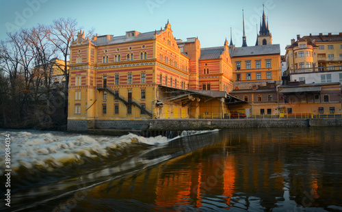 Old mill on Ohře River in Louny, Czech republic. Colorful yellow, red facade of old mill from 1880s. 