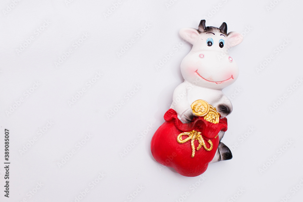 Magnet on the refrigerator in the form of a bull, a cow-a symbol of the New year and Christmas 2021. The blue sticker is for your records.