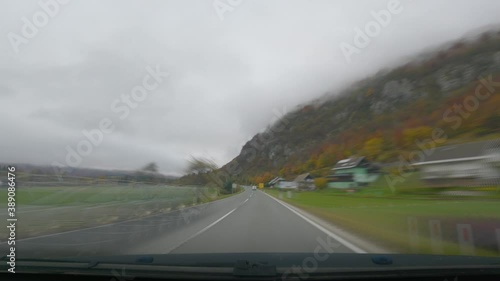 Sped up time lapse POV point of view dashcam dash camera view of driving on paved countryside road in Slovenia. Motion blur effect. Forward moving, real time, wide angle photo