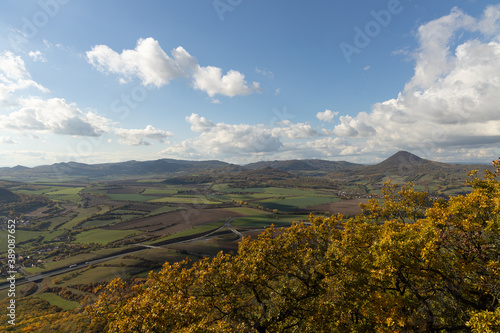 Autumn nature view from mountain Lovos to the horizon with hills and mountains and cloudy sky with trees in foreground