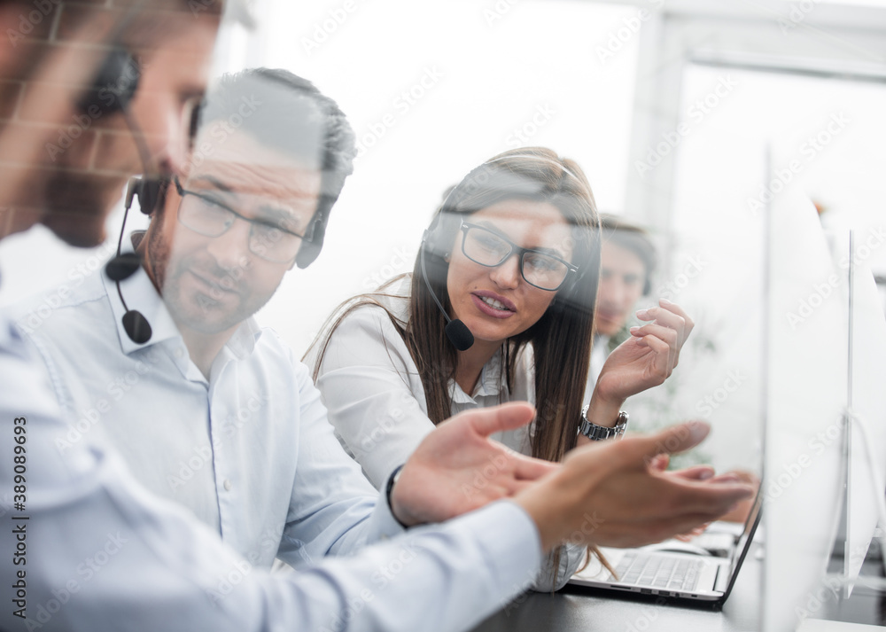 close up.smiling staff call centre to discuss business issues.